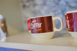 two coffee cups are sitting on a shelf at Una & Lake oasis in Bihać