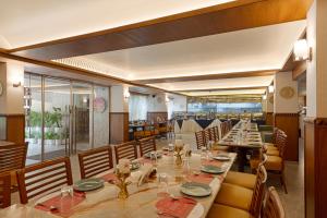 a dining room with a long table and chairs at Ginger Agra, Fatehabad Road in Agra