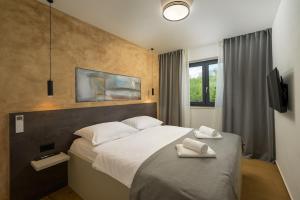 a bedroom with a bed with two towels on it at Villa Mochi by IstriaLux in Pićan +34 photos