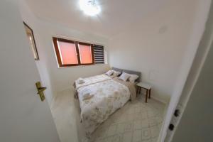 a small white bedroom with a bed and a window at Una & Lake oasis in Bihać +26 photos