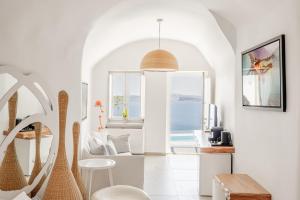 a living room with a view of the ocean at Mancave Sanctum Caldera Suites in Oia
