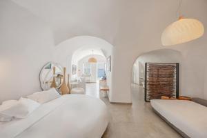 a white bedroom with two beds and a living room at Mancave Sanctum Caldera Suites in Oia +47 photos