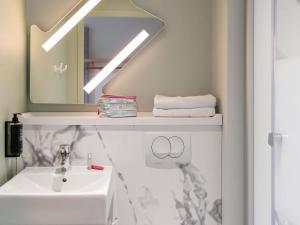 a bathroom with a sink and a mirror at ibis budget Rouen Centre Rive Gauche in Rouen +43 photos