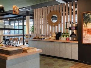 a restaurant kitchen with a counter and a counter top at ibis budget Rouen Centre Rive Gauche in Rouen