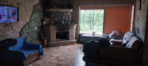 a living room with a couch and a fireplace at Dvalebi's Marani in Gori