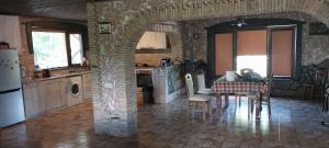 a kitchen with a table and chairs in a room at Dvalebi's Marani in Gori