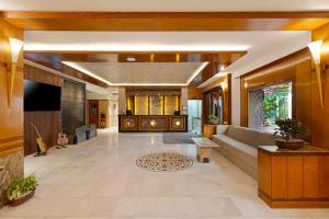 a large living room with a couch and a tv at Ginger Agra, Fatehabad Road in Agra