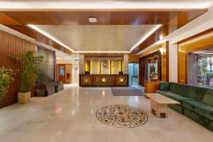 a lobby with a green couch and a table at Ginger Agra, Fatehabad Road in Agra +59 photos