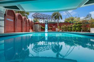 a swimming pool at a resort with a building at Ginger Agra, Fatehabad Road in Agra