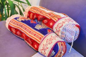 a colorful blanket sitting on top of a purple couch at Una & Lake oasis in Bihać
