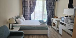 a small bedroom with a bed and a window at Sun Sea 1 studio sea view in Shkorpilovtsi +42 photos