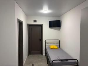 a bedroom with a bed with a yellow pillow on it at Stay Inn in Galaţi