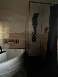 a bathroom with a sink and a bath tub at Sevchris in Saint-Laurent-de-la-Prée