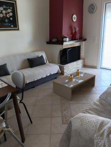 a living room with a couch and a fireplace at Beach Residence Walk to Beach Garden - Parking in Chalkida