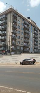 a car parked in front of a large building at 1 bedroom BNB Meru in Meru