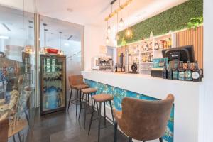 a bar with chairs and a counter in a restaurant at 1893 Hotel Boutique in Navajas