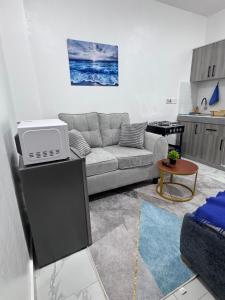 a living room with a couch and a table at Peace Nest bamburi in Mombasa