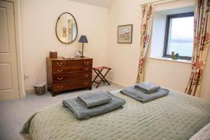 a bedroom with a bed with two pillows on it at Converted Barn - Romantic Countryside Escape in Cupar