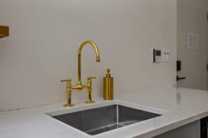 a kitchen sink with a gold faucet at Suite 1A at Maison Dupont a Dupont Circle Inn in Washington, D.C. +16 photos
