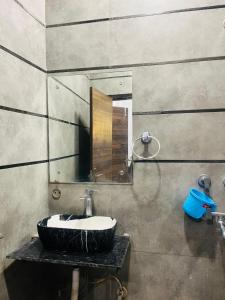 a bathroom with a sink and a mirror at Hotel Royal Residency - Laxmi Nagar in New Delhi