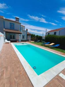 a swimming pool in front of a villa at Refugio de São Luis in São Luis
