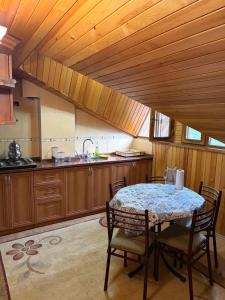 a kitchen with a table and chairs in a room at BAHAR APART in Ayder Yaylasi