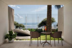 a room with a large window with a table and chairs at Don Gregory by Dunas - Adults Only in San Agustin +85 photos