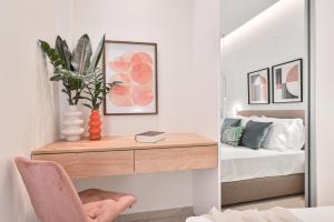 a bedroom with a desk and a bed at Elan Suites Preveza in Preveza