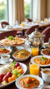 a table topped with plates of food and drinks at Hotel Royal Residency - Laxmi Nagar in New Delhi