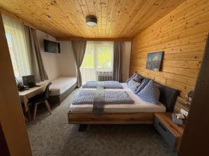 a bedroom with a large bed in a wooden room at Pension Mitterwallner in Schladming