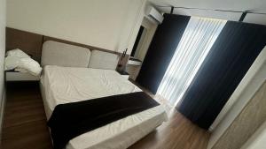 a small bedroom with a bed and a window at Apt Elite in Khujand +1 photo