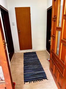 a hallway with a door and a rug on the floor at Weekend House in Vrelo in Jelovica +17 photos