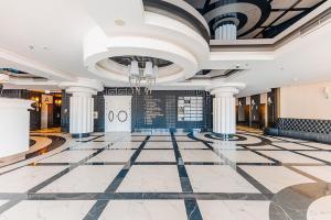 a lobby with a large tile floor and a ceiling at Hanza Tower - Luxurious Apartment 60m2 - 15th Floor City View in Szczecin