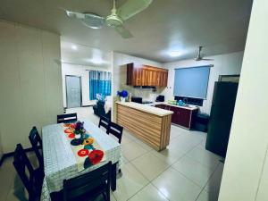 a kitchen and dining room with a table and chairs at Apartment in Port Moresby - Short Stays in Port Moresby