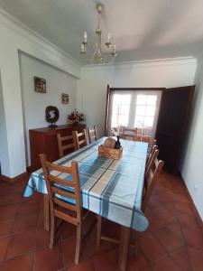 a dining room with a blue table and chairs at Refugio de São Luis in São Luis