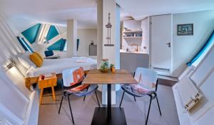 a room with a bed and a table and chairs at Stayokay Hostel Rotterdam - fully renovated April 2026 in Rotterdam