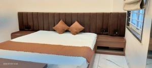 a bedroom with a bed with two pillows on it at Vista10 in Bhopal