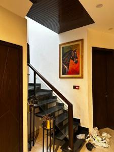 a staircase in a house with a painting on the wall at Prestige Home in Lahore +16 photos