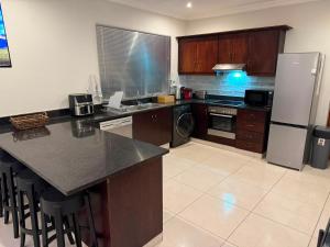 a kitchen with a refrigerator and a counter top at Cabana Vista 4 in La Mercy +16 photos