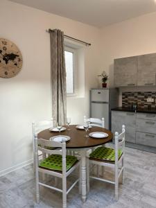 a kitchen with a wooden table and two chairs at Eymet Holiday Rentals in Eymet