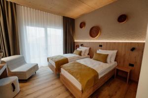 a hotel room with two beds and a window at Hotel Narcisa in Veržej +15 photos