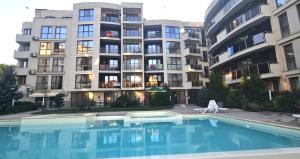 a swimming pool in front of a building at Sun Sea 1 studio sea view in Shkorpilovtsi