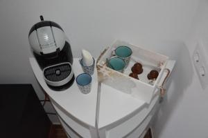 a white table with a blender and cupcakes on it at Hostal La Mancha in Ruidera