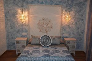 a bedroom with a bed and two night stands at Hostal La Mancha in Ruidera