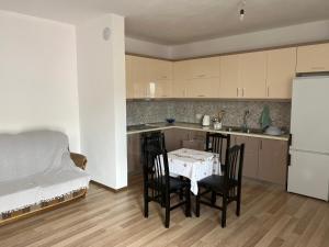 a kitchen with a table and chairs and a bed at LakeView Pogradec in Pogradec