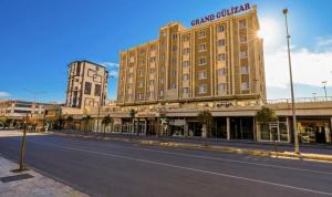 an empty street in front of a large building at Grand Gülizar Otel in Urfa