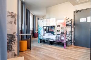 a room with a bed in the middle of a room at a&o Hostel Venezia Mestre in Mestre +47 photos