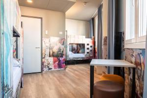 a room with a table and a hallway at a&o Hostel Venezia Mestre in Mestre
