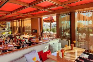 a restaurant with tables and chairs on a balcony at Casa Brera, a Luxury Collection Hotel, Milan in Milan