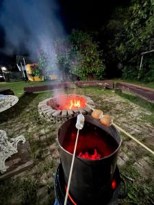 a large pot of fire in a yard at Pousada e Museu JK in Ubajara +48 photos